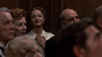 Movie still from “The Last Tycoon” (1976), directed by Elia Kazan – A woman in a white shirt is holding a necklace; Close Up shot, Low angle