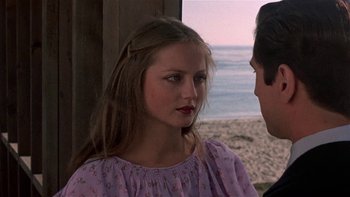 Movie still from “The Last Tycoon” (1976), directed by Elia Kazan – A young girl wearing a purple dress talking to a young man; Close Up shot, Over the shoulder angle
