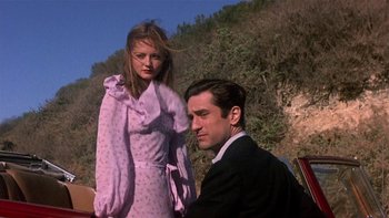 Movie still from “The Last Tycoon” (1976), directed by Elia Kazan – A man and a woman standing next to each other on a hill; Medium shot, Low angle