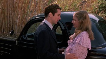Movie still from “The Last Tycoon” (1976), directed by Elia Kazan – A man and a woman standing in front of a black car; Medium shot, Over the shoulder angle