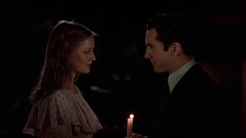Movie still from “The Last Tycoon” (1976), directed by Elia Kazan – A man and a woman holding a lit candle in front of each other; Close Up shot, Over the shoulder angle