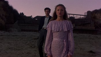 Movie still from “The Last Tycoon” (1976), directed by Elia Kazan – A man and a woman standing next to each other on a beach; Medium shot, Low angle