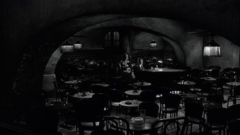 Movie still from “The Last Tycoon” (1976), directed by Elia Kazan – People sitting at tables in an empty restaurant; Wide shot, High angle