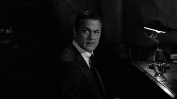 Movie still from “The Last Tycoon” (1976), directed by Elia Kazan – Black and white photograph of a man wearing a suit and tie; Close Up shot, Low angle
