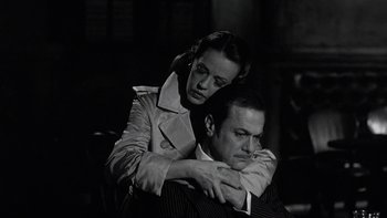 Movie still from “The Last Tycoon” (1976), directed by Elia Kazan – A man and a woman sitting on a chair; Close Up shot, Low angle