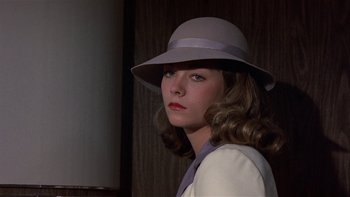 Movie still from “The Last Tycoon” (1976), directed by Elia Kazan – A woman wearing a hat and a white shirt; Close Up shot, Low angle