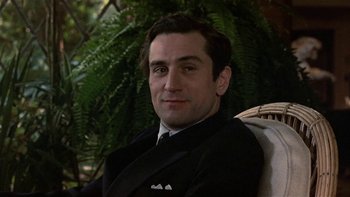 Movie still from “The Last Tycoon” (1976), directed by Elia Kazan – A person wearing a suit and tie; Close Up shot, Low angle