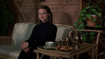 Movie still from “The Last Tycoon” (1976), directed by Elia Kazan – A woman sitting on a couch in front of a tray of food; Medium shot, High angle