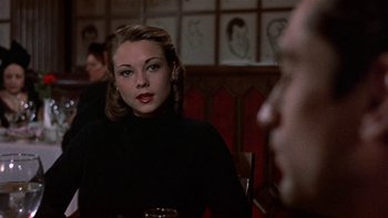 Movie still from “The Last Tycoon” (1976), directed by Elia Kazan – A woman sitting at a table in front of a man; Close Up shot, Over the shoulder angle