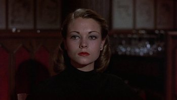 Movie still from “The Last Tycoon” (1976), directed by Elia Kazan – A woman in a black shirt is looking at the camera; Close Up shot, Low angle