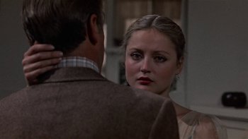 Movie still from “The Last Tycoon” (1976), directed by Elia Kazan – A man and a woman looking at one another in front of a mirror; Close Up shot, Over the shoulder angle