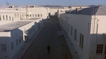 Movie still from “The Last Tycoon” (1976), directed by Elia Kazan – A man is walking down a street in a city; Extreme Wide shot, High angle
