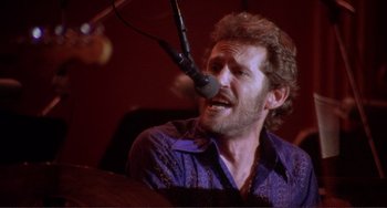 Movie still from “The Last Waltz” (1978), directed by Martin Scorsese – A man with a microphone in his mouth; Close Up shot, Low angle