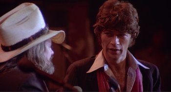 Movie still from “The Last Waltz” (1978), directed by Martin Scorsese – A man in a cowboy hat talking to another man in a suit; Close Up shot, Over the shoulder angle
