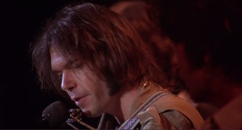 Movie still from “The Last Waltz” (1978), directed by Martin Scorsese – A person with long hair; Close Up shot, Low angle