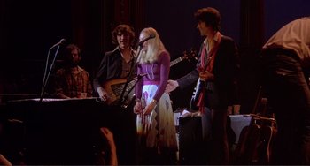 Movie still from “The Last Waltz” (1978), directed by Martin Scorsese – A group of people standing on a stage with instruments; Wide shot, Low angle