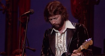 Movie still from “The Last Waltz” (1978), directed by Martin Scorsese – A man with a beard is holding a guitar; Close Up shot, Low angle