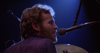 Movie still from “The Last Waltz” (1978), directed by Martin Scorsese – A person with a microphone; Close Up shot, Low angle