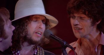 Movie still from “The Last Waltz” (1978), directed by Martin Scorsese – A man in a white hat singing into a microphone; Close Up shot, Low angle