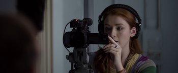 Movie still from “The Lazarus Effect” (2015), directed by David Gelb – A woman with headphones on looking at a video camera; Close Up shot, Over the shoulder angle