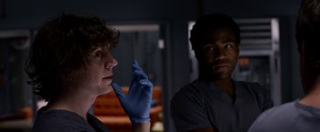 Movie still from “The Lazarus Effect” (2015), directed by David Gelb – Two people wearing blue gloves and one wearing a blue glove; Close Up shot, Over the shoulder angle