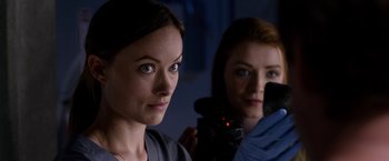 Movie still from “The Lazarus Effect” (2015), directed by David Gelb – Two women are looking into a mirror while one of them is holding a video camera; Close Up shot, Over the shoulder angle