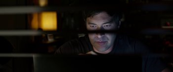 Movie still from “The Lazarus Effect” (2015), directed by David Gelb – A person looking at a computer screen; Close Up shot, Low angle