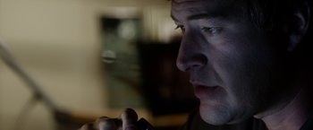 Movie still from “The Lazarus Effect” (2015), directed by David Gelb – A man's face as he holds a cell phone in his hand; Close Up shot, Low angle