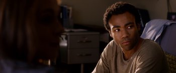 Movie still from “The Lazarus Effect” (2015), directed by David Gelb – A man sitting in front of a desk in a room; Close Up shot, Over the shoulder angle