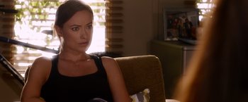 Movie still from “The Lazarus Effect” (2015), directed by David Gelb – A woman sitting on a couch in a living room; Close Up shot, Over the shoulder angle