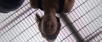 Movie still from “The Lazarus Effect” (2015), directed by David Gelb – A woman hanging upside down in a cage; Close Up shot, Overhead angle