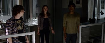 Movie still from “The Lazarus Effect” (2015), directed by David Gelb – A woman and a man standing next to each other in a dark room; Medium shot, Low angle