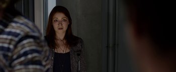 Movie still from “The Lazarus Effect” (2015), directed by David Gelb – A young woman standing in a dark room; Close Up shot, Over the shoulder angle