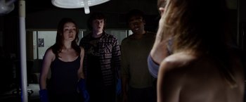 Movie still from “The Lazarus Effect” (2015), directed by David Gelb – A group of young people standing in a room together; Medium shot, Low angle