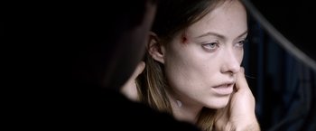 Movie still from “The Lazarus Effect” (2015), directed by David Gelb – A person with a bruise on their face; Close Up shot, Over the shoulder angle