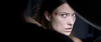 Movie still from “The Lazarus Effect” (2015), directed by David Gelb – A person with a bruise on their face; Close Up shot, Over the shoulder angle