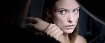 Movie still from “The Lazarus Effect” (2015), directed by David Gelb – A woman holding a man's hand in front of her face; Close Up shot, Over the shoulder angle