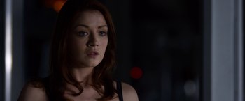 Movie still from “The Lazarus Effect” (2015), directed by David Gelb – A person with long red hair; Close Up shot, Over the shoulder angle