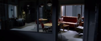 Movie still from “The Lazarus Effect” (2015), directed by David Gelb – A living room with a red couch and a red chair; Extreme Wide shot, High angle