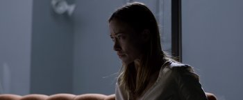 Movie still from “The Lazarus Effect” (2015), directed by David Gelb – A woman sitting in front of a window looking at the camera; Close Up shot, Over the shoulder angle