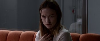 Movie still from “The Lazarus Effect” (2015), directed by David Gelb – A young woman is holding her hand to her chest; Close Up shot, Over the shoulder angle
