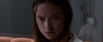 Movie still from “The Lazarus Effect” (2015), directed by David Gelb – A person with long brown hair; Close Up shot, Over the shoulder angle