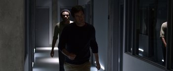 Movie still from “The Lazarus Effect” (2015), directed by David Gelb – Two men are walking in a dark hallway; Medium shot, Over the shoulder angle