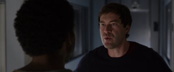 Movie still from “The Lazarus Effect” (2015), directed by David Gelb – A man talking to another man in a dark room; Close Up shot, Over the shoulder angle