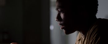 Movie still from “The Lazarus Effect” (2015), directed by David Gelb – A man's face in the dark; Close Up shot, Low angle