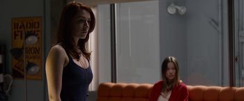 Movie still from “The Lazarus Effect” (2015), directed by David Gelb – A woman standing next to another woman sitting in a chair; Medium shot, Over the shoulder angle