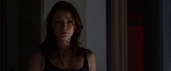 Movie still from “The Lazarus Effect” (2015), directed by David Gelb – A beautiful young woman with long brown hair wearing a necklace; Close Up shot, Over the shoulder angle