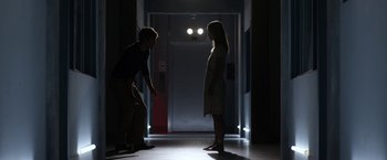 Movie still from “The Lazarus Effect” (2015), directed by David Gelb – A man and a woman are standing in a dark room; Wide shot, Low angle