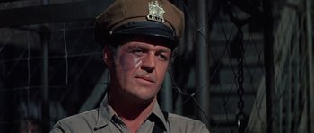 Movie still from “The Learning Tree” (1969), directed by Gordon Parks – A man in a police uniform with a bandage on his face; Close Up shot, Low angle