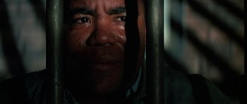 Movie still from “The Learning Tree” (1969), directed by Gordon Parks – A person with his eyes wide open crying; Close Up shot, High angle